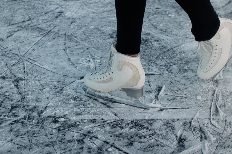 person with iceskates on skating on an ice rink in winter