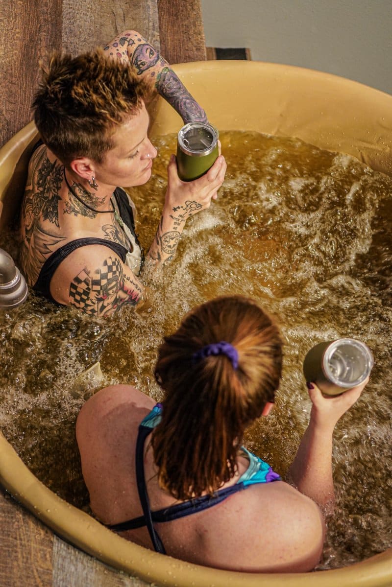 two women in a beer bath at Oakwell Beer Spa in Denver