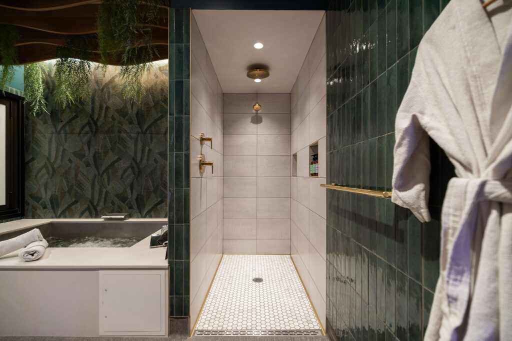 One of Oakwell’s private suites with a rain shower, soaking tub, and plush bath robes
