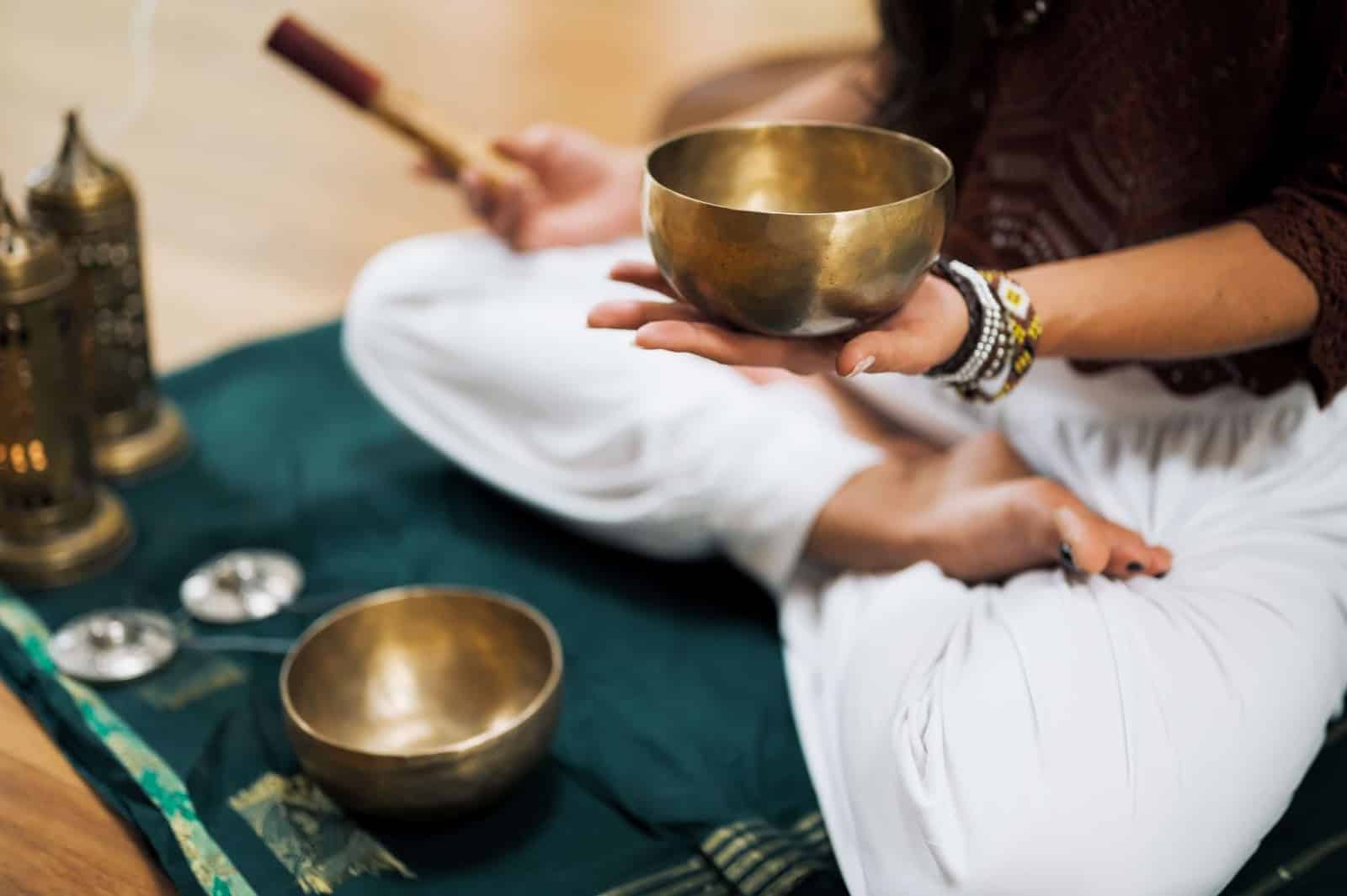 person holding bowl for sound bath