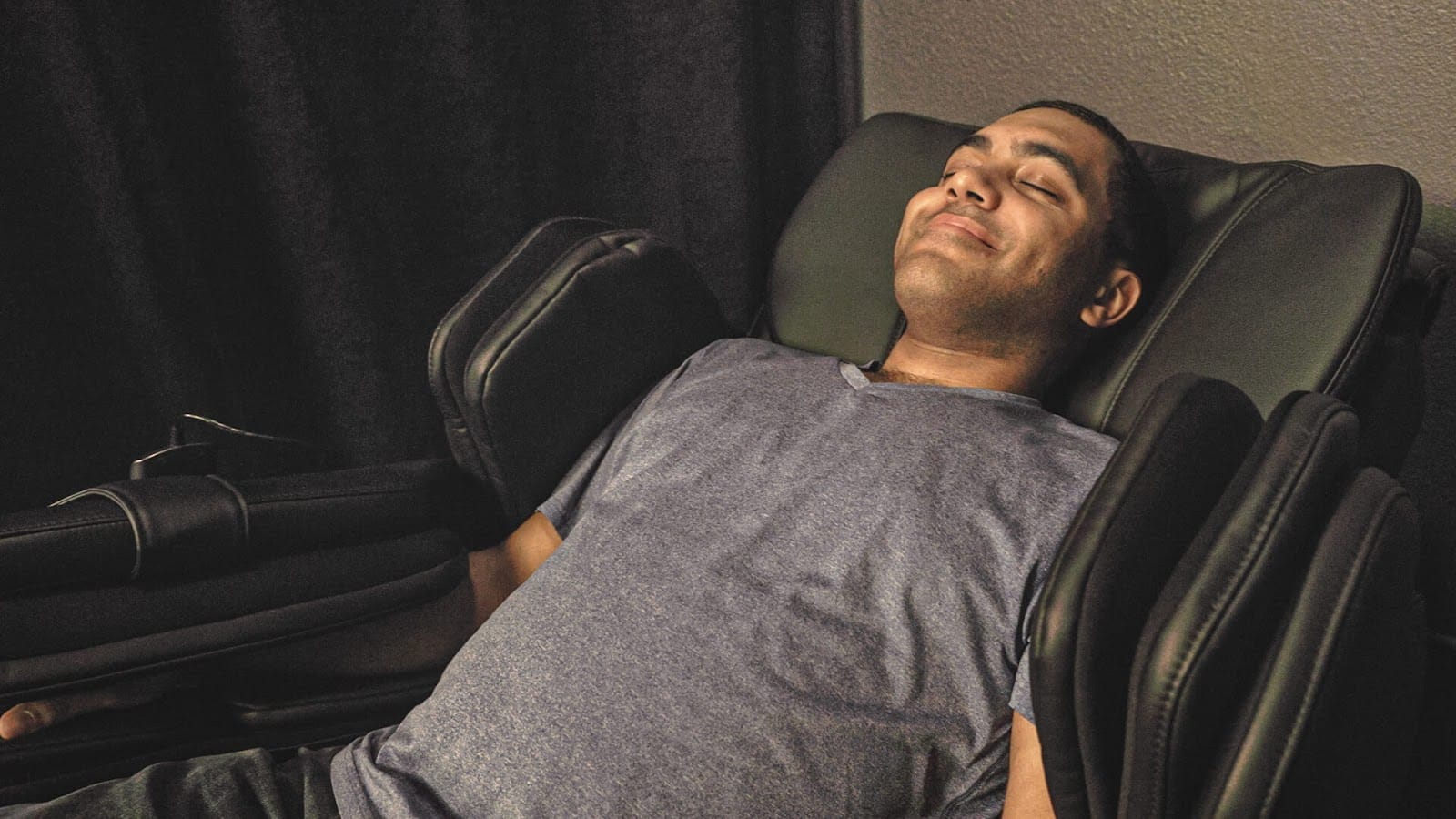 man lying in a Zero Gravity Massage chair at Oakwell Beer Spa in Denver