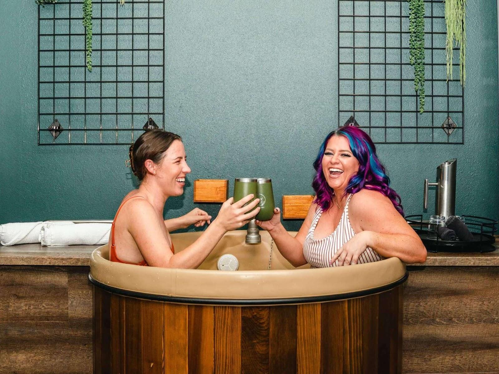 Two girls taking a beer bath at Oakwell Beer Spa for girls weekend in Denver