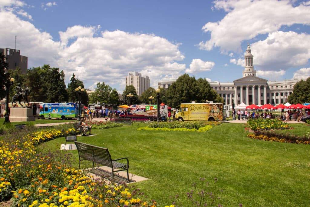 Civic Center Park with benches, flowers, and food trucks