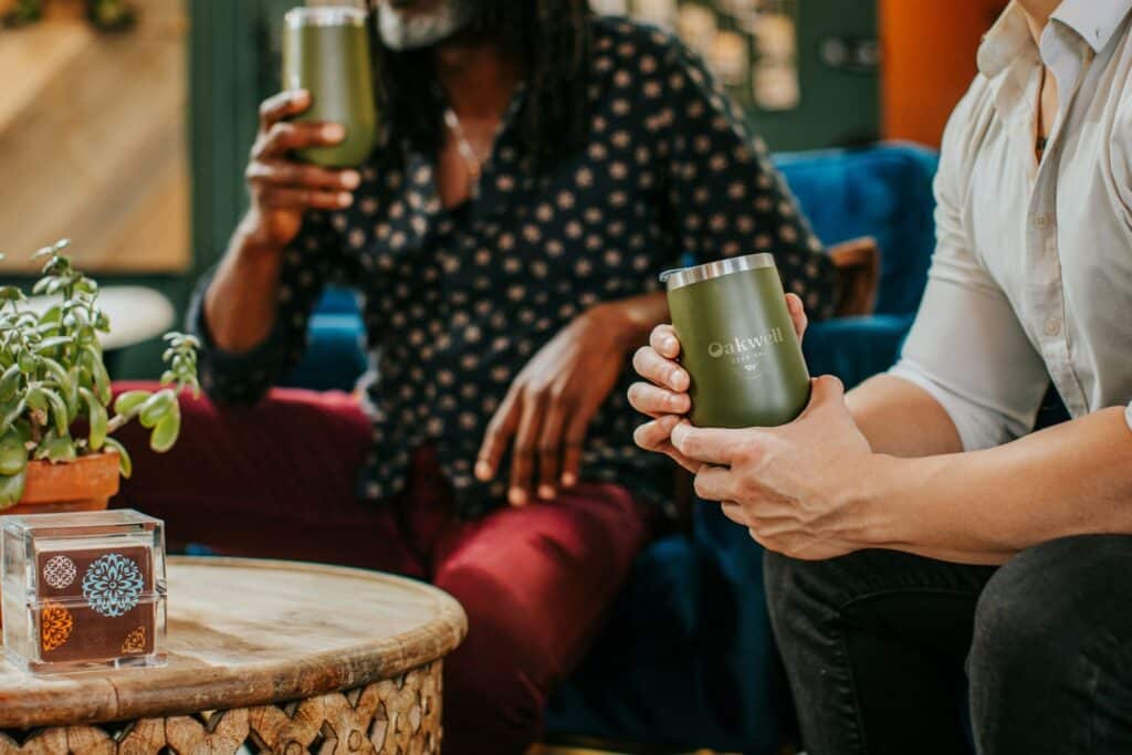 A couple relaxes while enjoying craft beverages in the Oakwell taproom