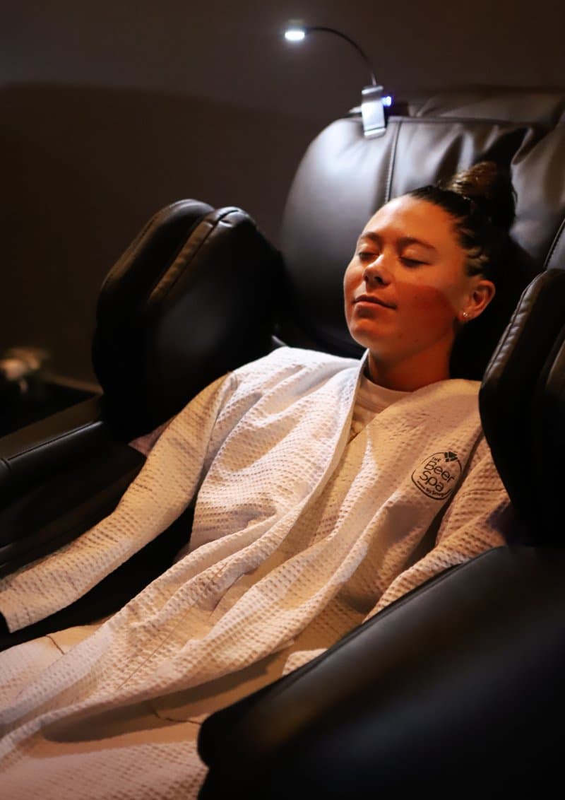 girl in a Zero Gravity Massage chair at Oakwell Beer Spa in Denver