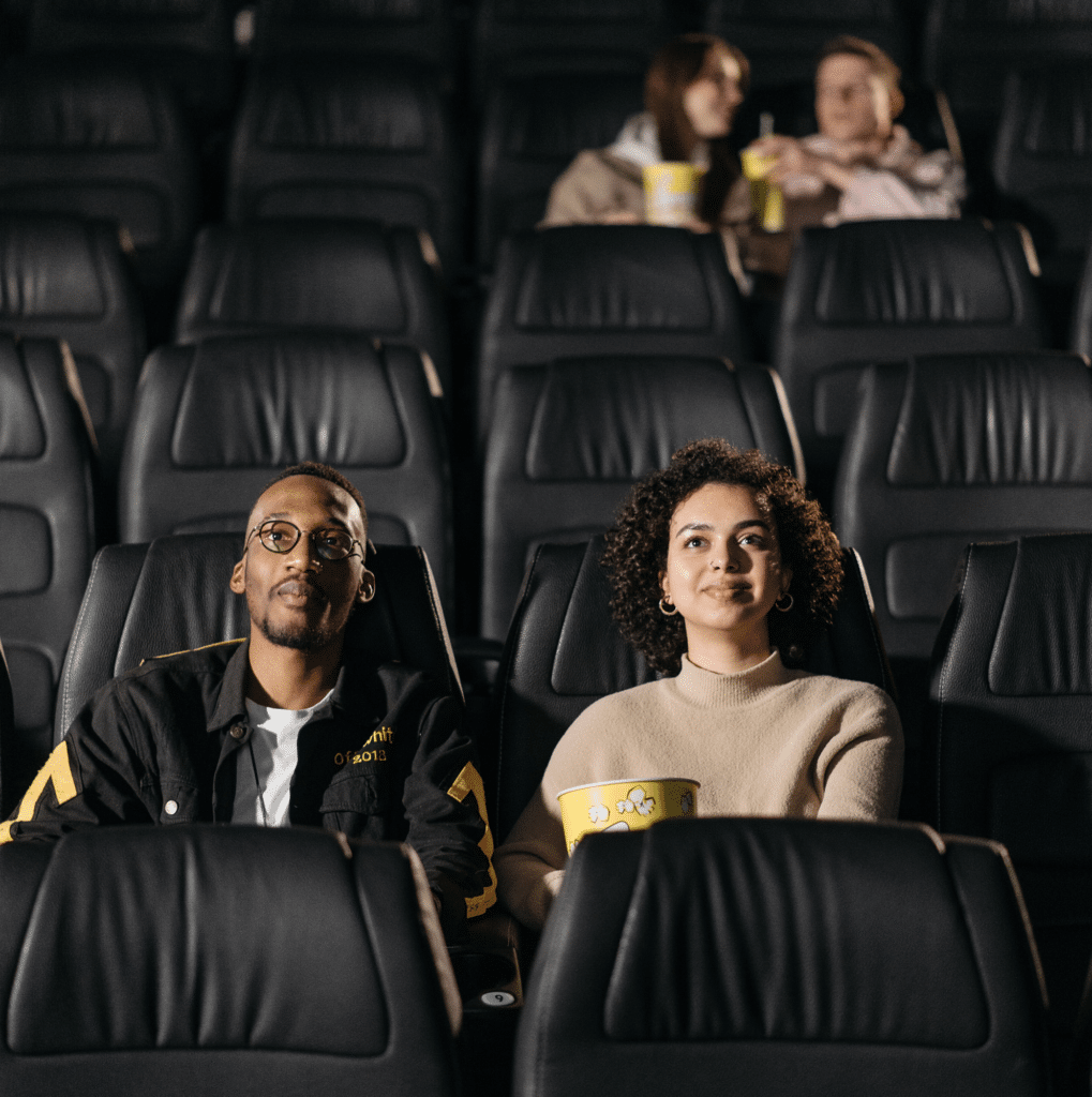 Couple enjoying a movie at a theater