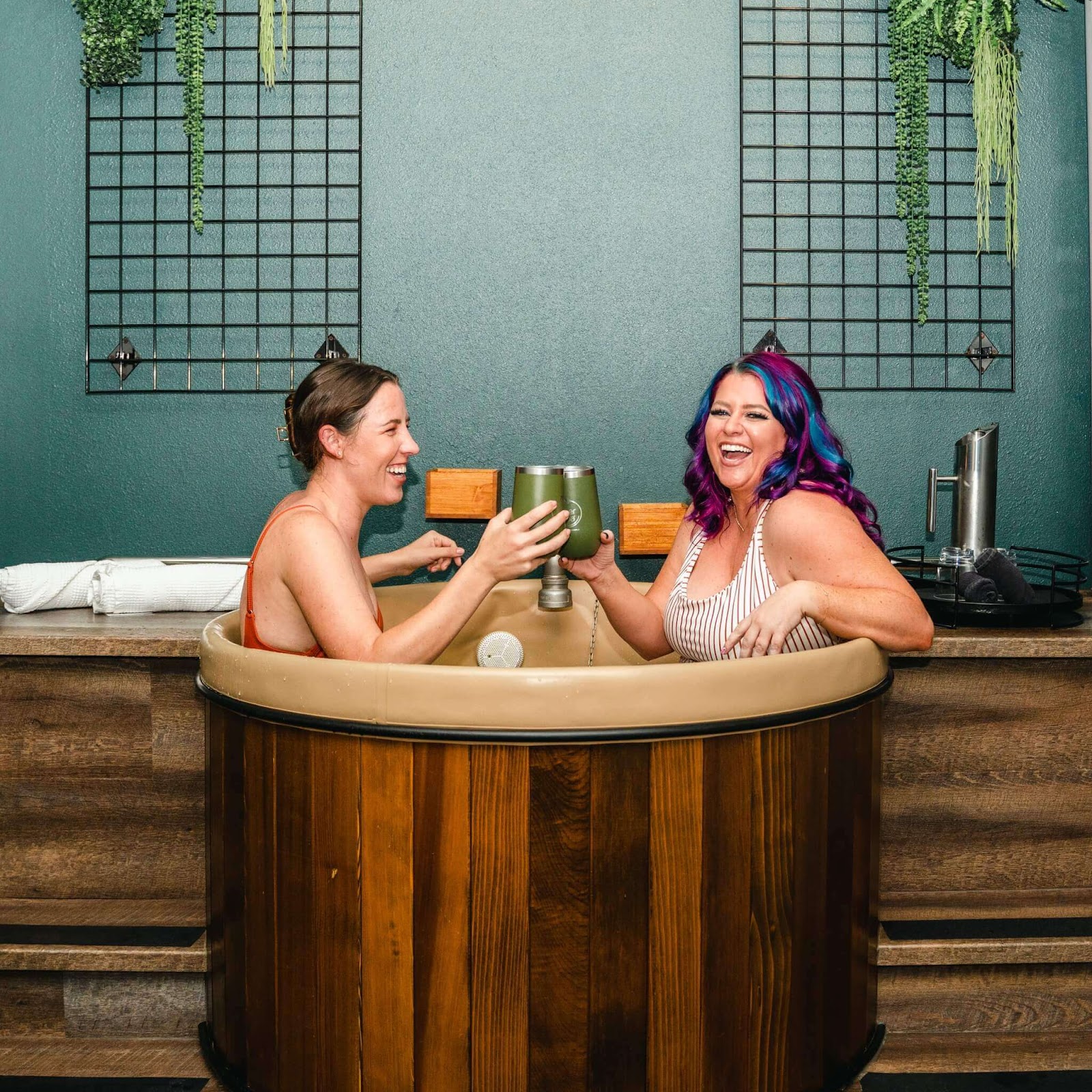 Two women taking a beer bath at Oakwell Beer Spa for moms night out in Denver