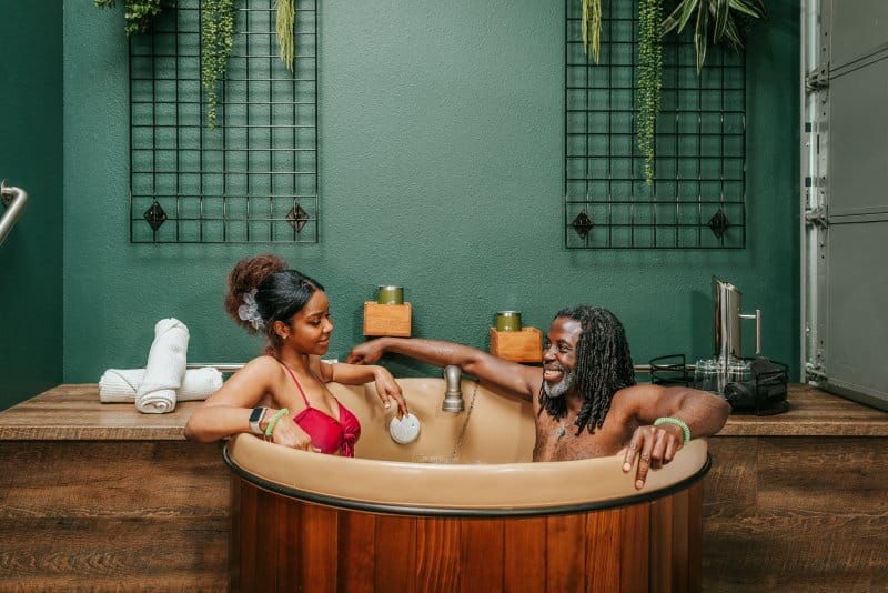 Man and woman relaxing in beer bath at Oakwell Beer Spa in Denver