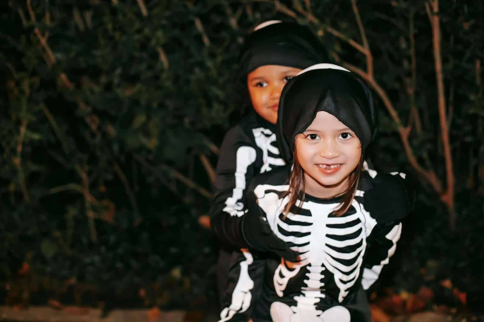 Two children dressed up as skeletons for Halloween