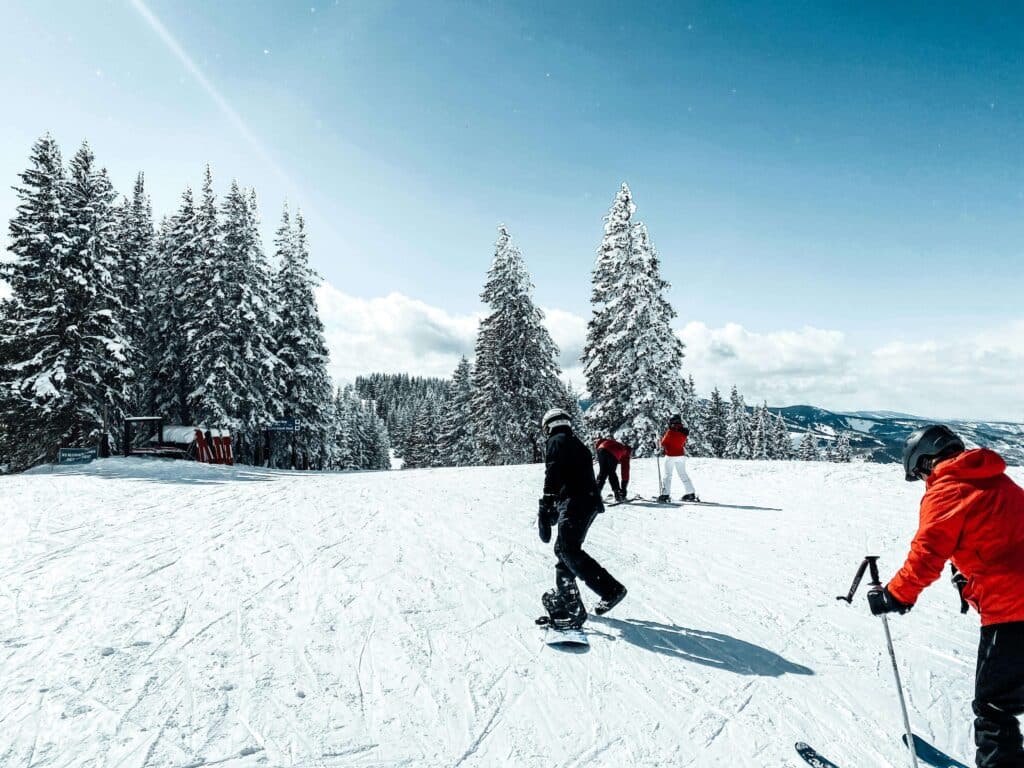 People skiing in Vail, Colorado, surrounded by snow