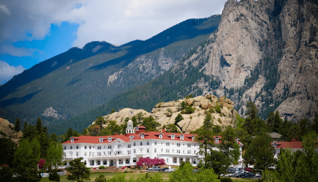 Stanley Hotel in Estes Park, CO with mountains in background