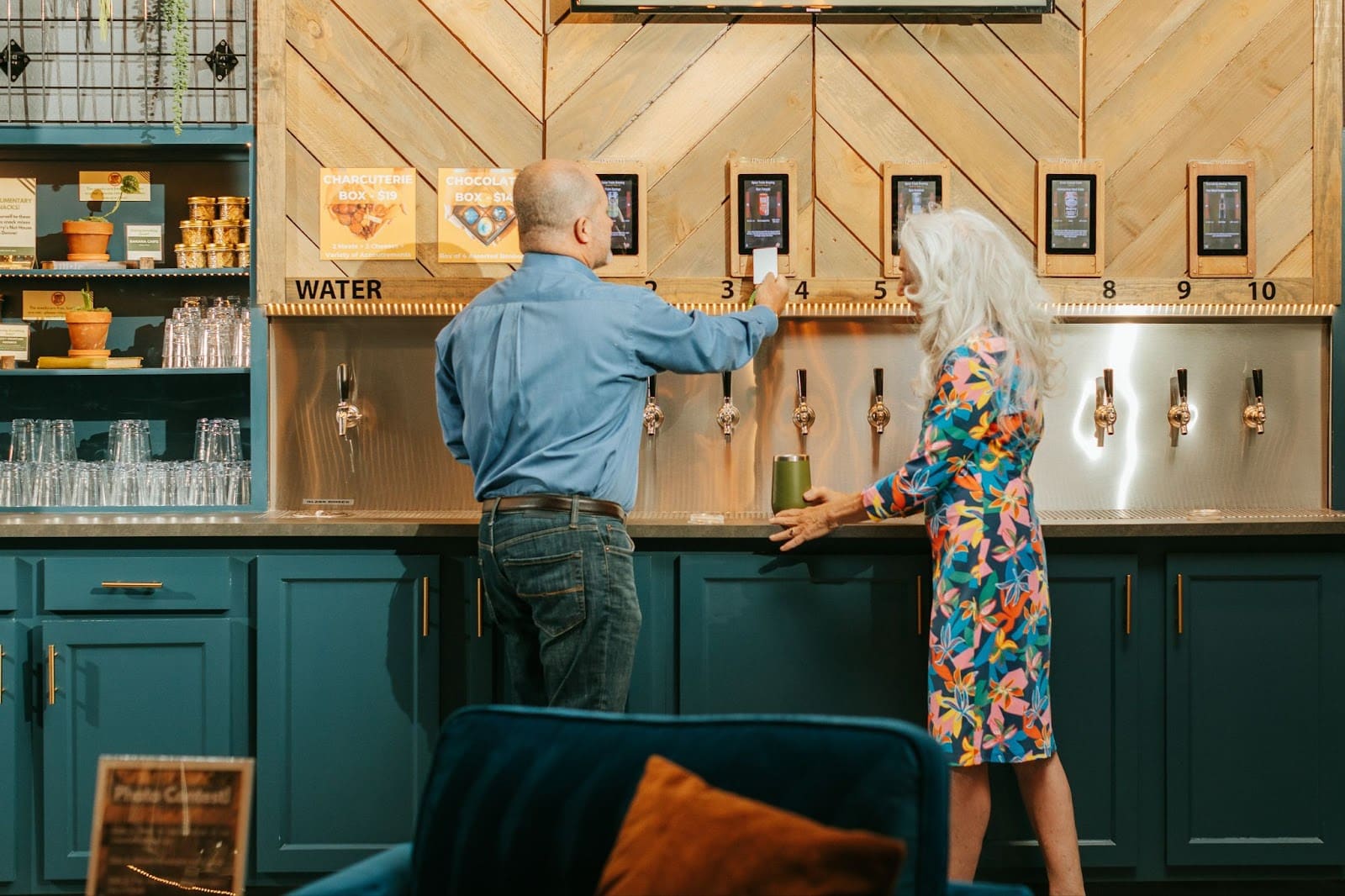 man and woman at self-serve beer wall at Oakwell Beer Spa in Denver