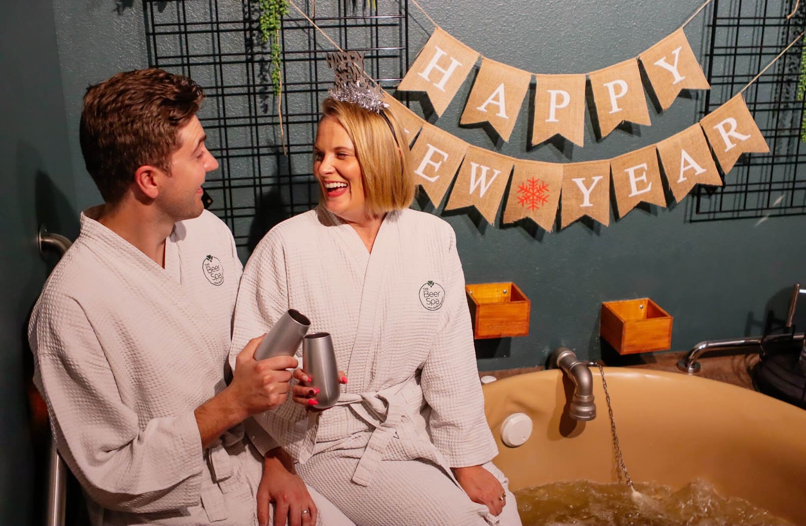 Couple with champagne at Oakwell Beer Spa for a New Years spa package