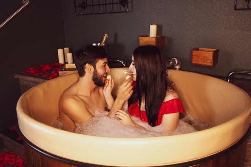 Couple taking a beer bath at Oakwell Beer Spa for anniversary date in Denver