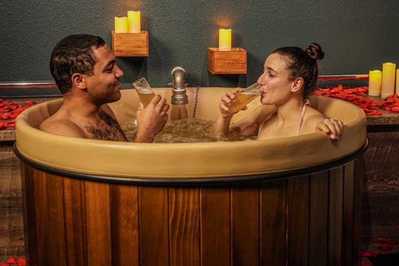 couple relaxing in a beer bath at Oakwell Beer Spa