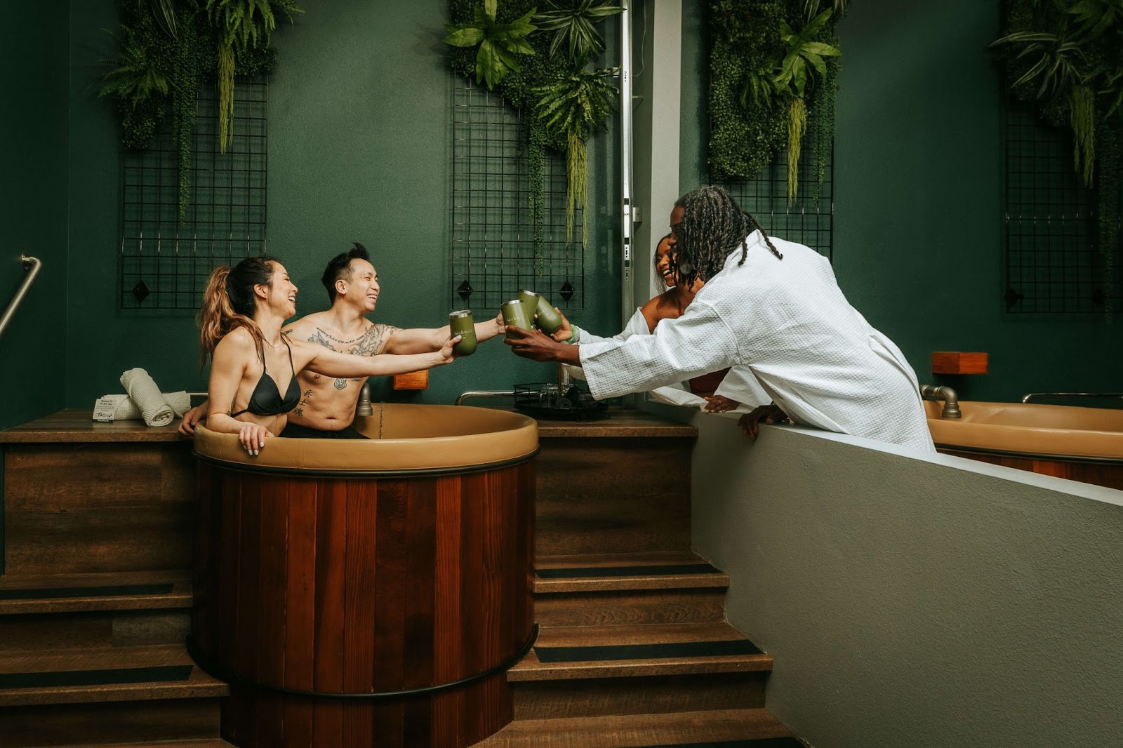 Four people with drinks at Oakwell Beer Spa for a spa birthday party