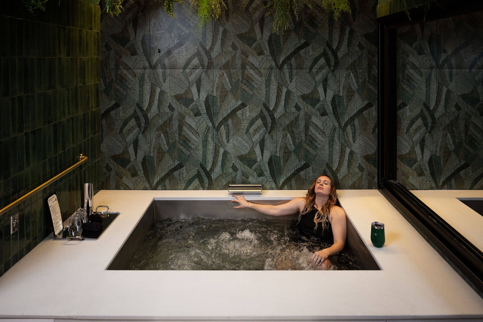 Woman taking a beer bath at Oakwell Beer Spa in Denver in June