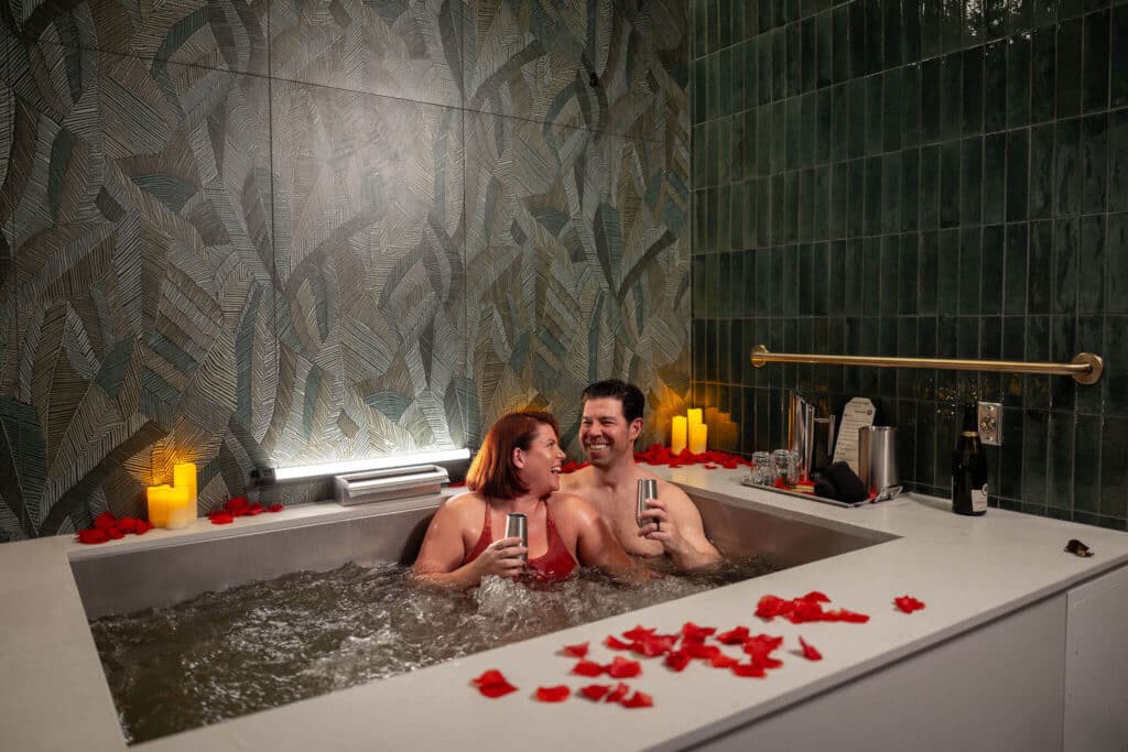 Couple taking a beer bath at Oakwell Beer Spa for date night in Denver