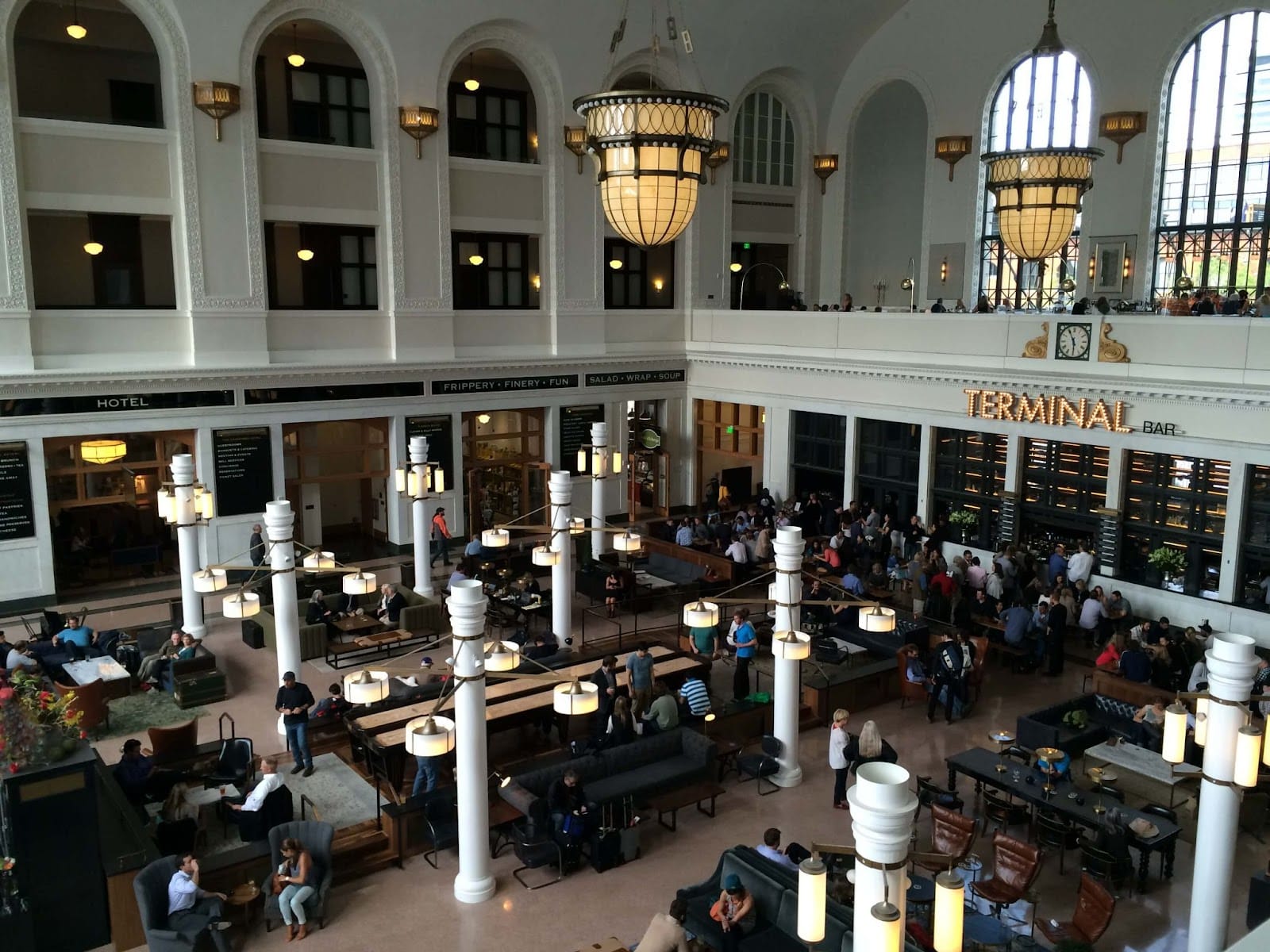 People sitting around the Denver Union Station at The Crawford Hotel and Terminal Bar