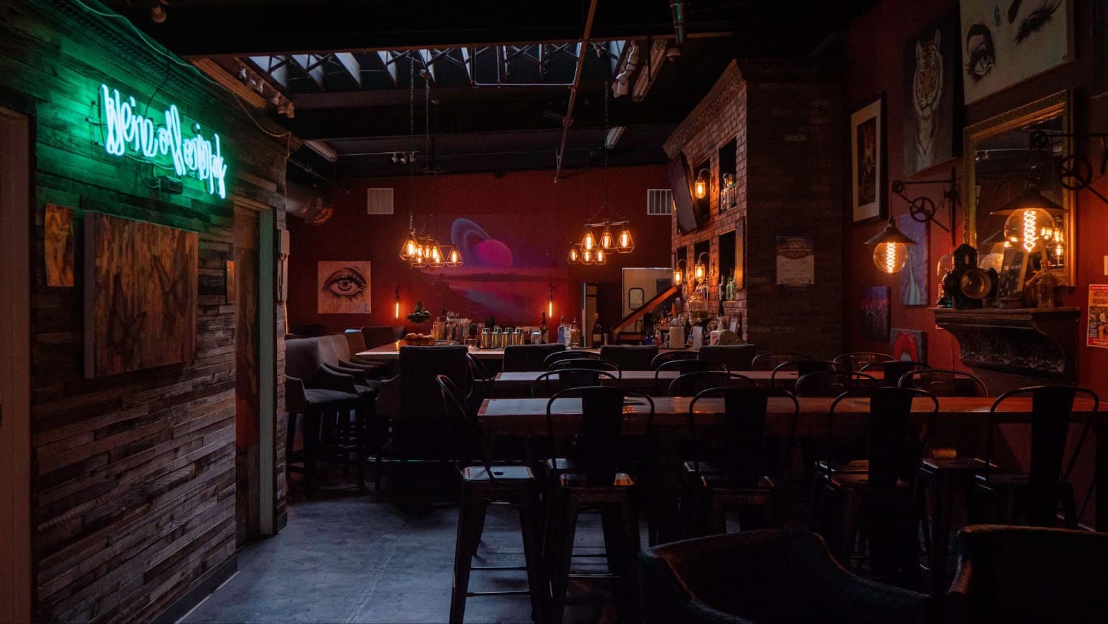 Inside of Millers & Rossi bar in Denver with seating and dim lights