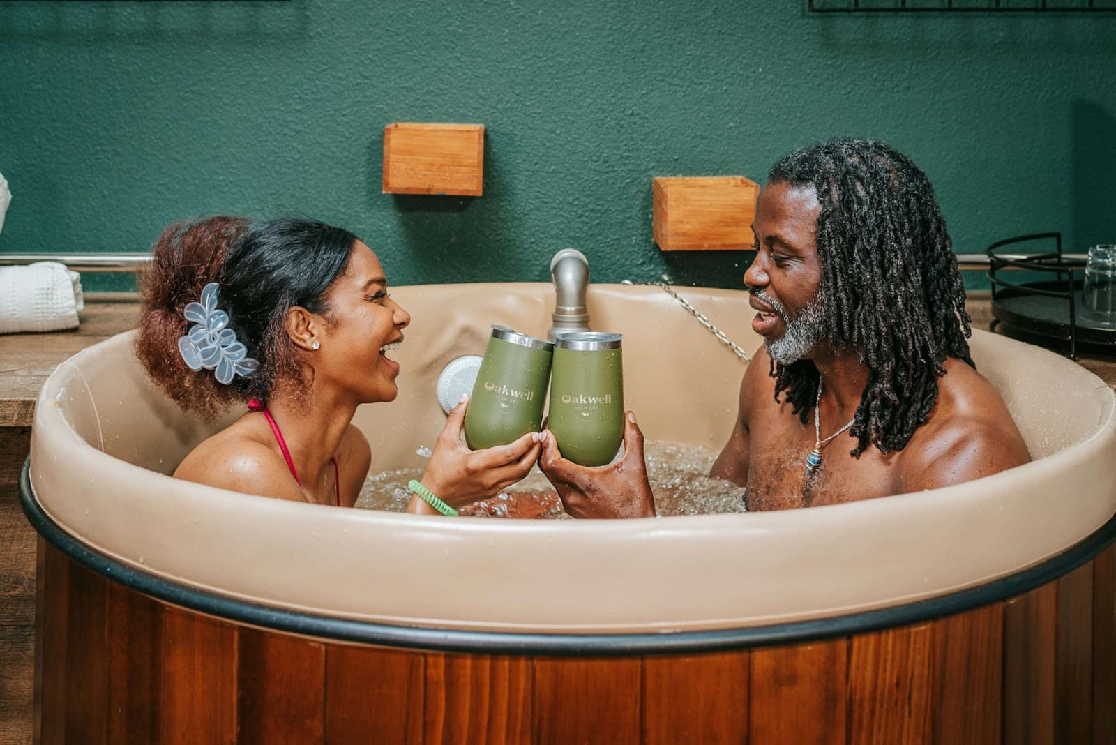 Couple smiling at each other and taking a beer bath at Oakwell Beer Spa in Denver