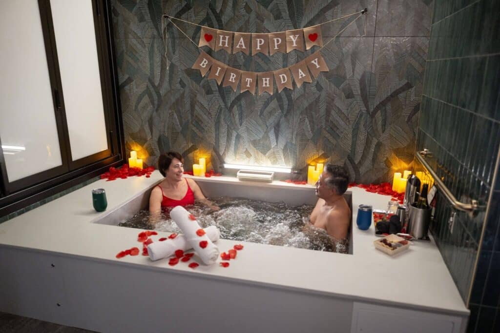 Couple taking a beer bath at Oakwell Beer Spa with birthday decor