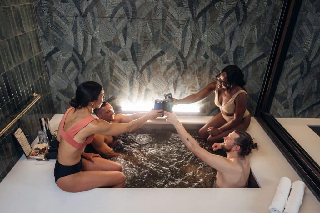 Four people taking a beer bath at Oakwell Beer Spa in Denver