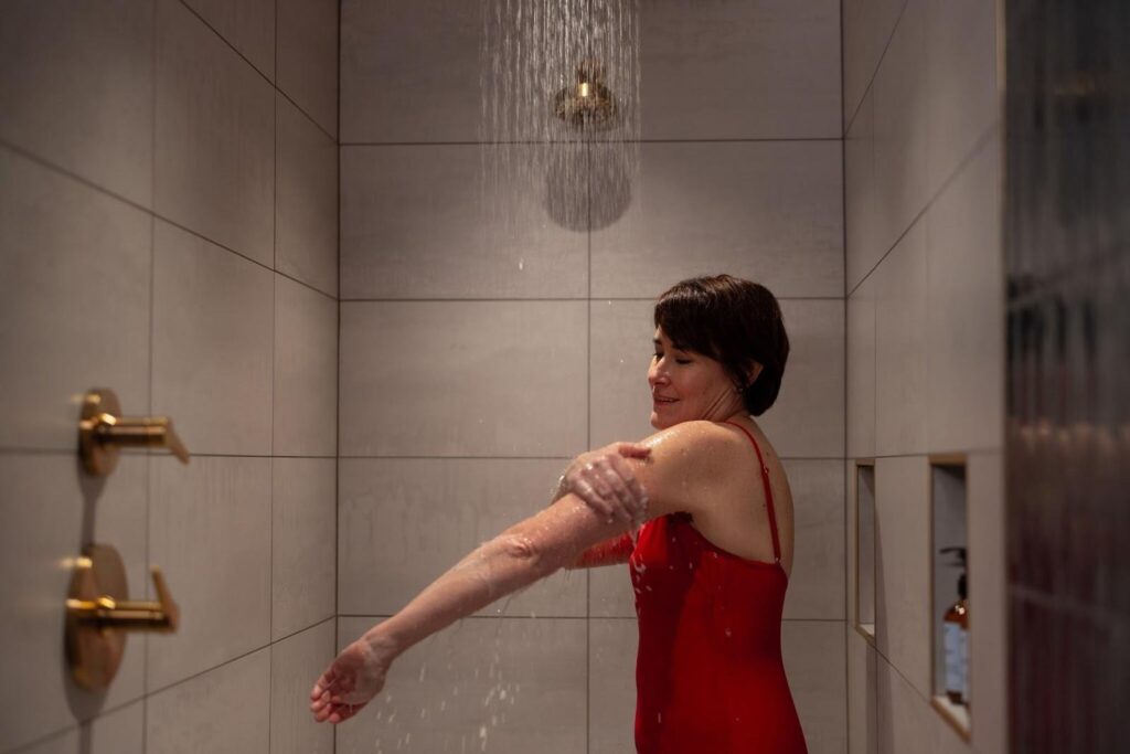 Woman wearing swimsuit and taking shower at Oakwell Beer Spa