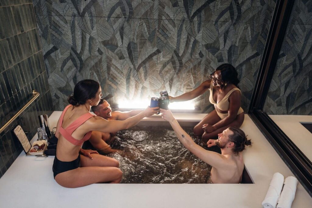 Four people taking a beer bath at Oakwell Beer Spa in Denver