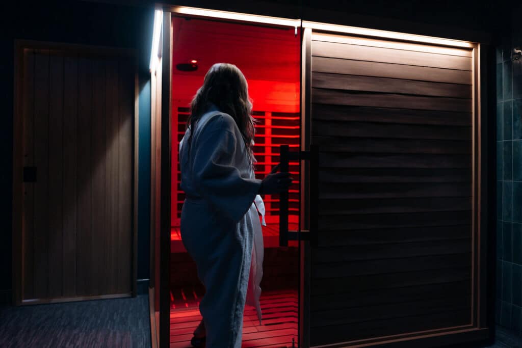 A woman in a white robe enters the Oakwell infrared therapy suite