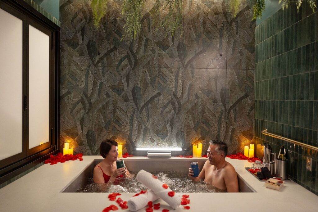 A couple soaks in an herbal, beer-infused bath in their private suite