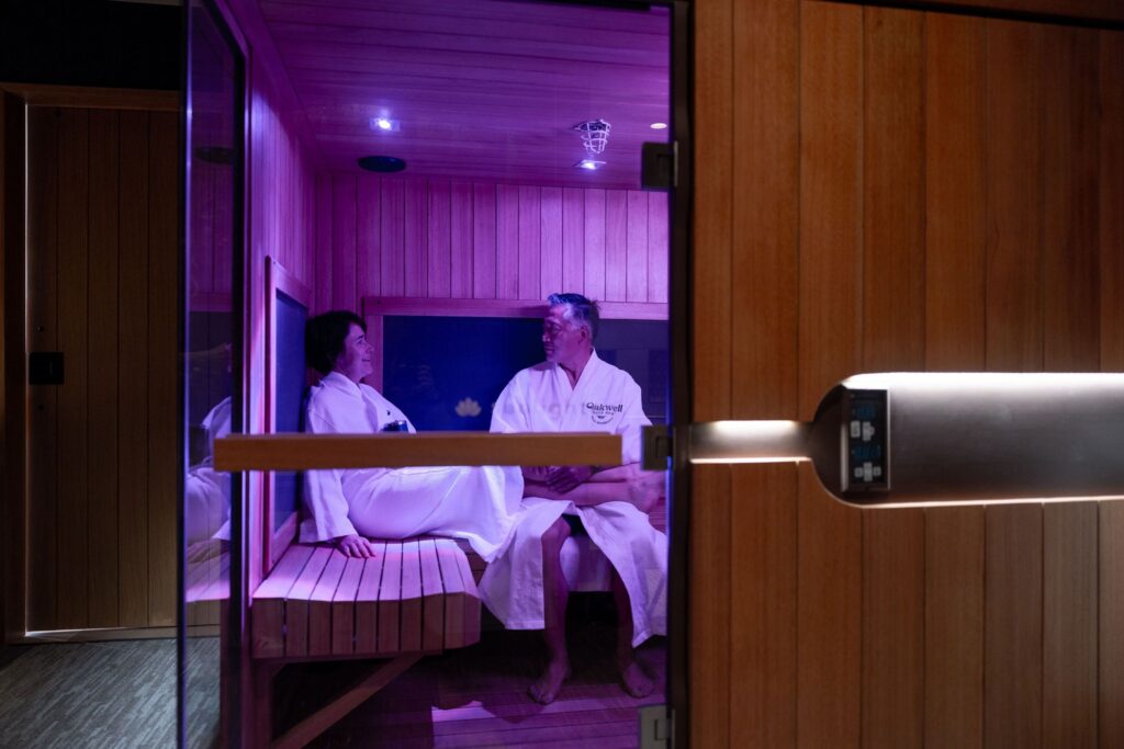A couple in robes chats in an Oakwell infrared sauna