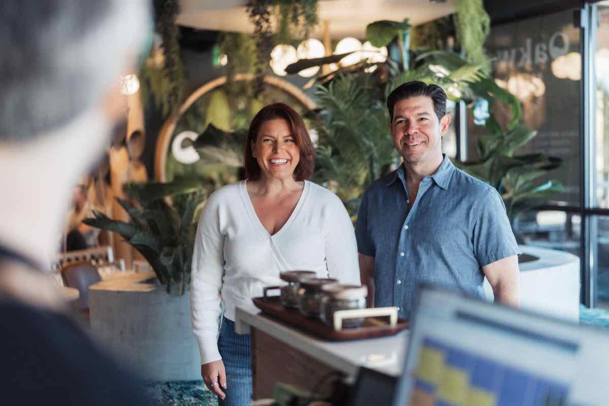A smiling couple enters Oakwell to check in for a taproom experience