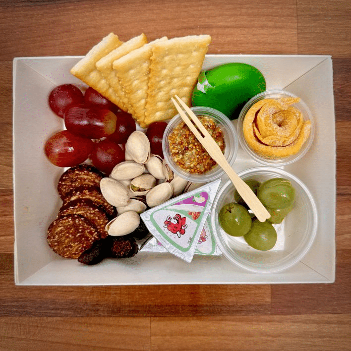 Oakwell’s vegan charcuterie board includes plant-based cheese, nuts, olives, mustard, fruit, and crackers