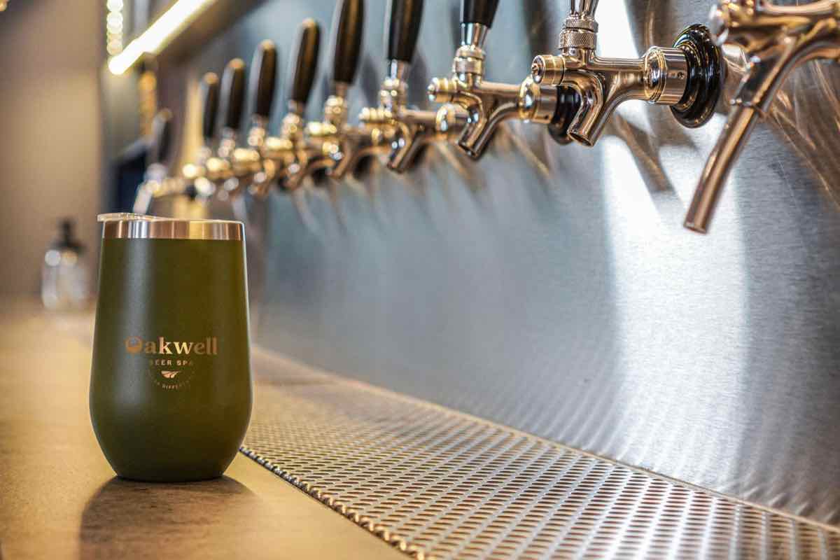 A close-up of Oakwell's insulated metal drinking glass by the beer taps